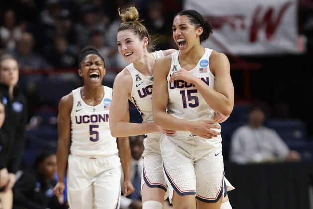 Connecticut's Crystal Dangerfield (5) and Katie Lou Samuelson (33) celebrate a 3-point basket by Gabby Williams (15) during the first half in a regional semifinal against Duke at the NCAA women's college basketball tournament Saturday, March 24, 2018, in Albany, N.Y. (AP Photo/Frank Franklin II)