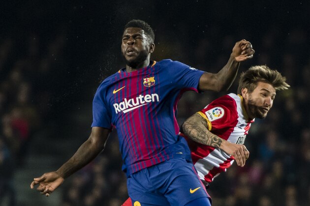 BARCELONA, SPAIN - FEBRUARY 24: Samuel Umtiti of FC Barcelona (L) fights for the ball with Cristian Portugues Manzanera, Portu, of Girona FC (R) during the La Liga 2017-18 match between FC Barcelona and Girona FC at Camp Nou on 24 February 2018 in Barcelona, Spain. (Photo by Power Sport Images/Getty Images)