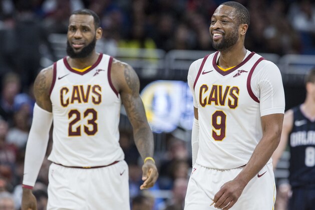 Friends and teammates Cleveland Cavaliers forward LeBron James (23) and Cleveland Cavaliers guard Dwyane Wade (9) walk the court during the second half of an NBA basketball game against the Orlando Magic in Orlando, Fla., Saturday, Jan. 6, 2018. James and Wade were also teammates on the Miami Heat. (AP Photo/Willie J. Allen Jr.)