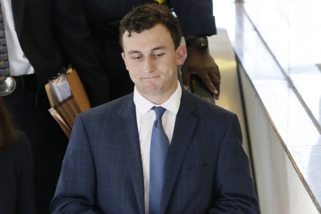 Former Cleveland Browns quarterback Johnny Manziel takes an escalator after making his initial court appearance, Thursday, May 5, 2016, in Dallas. The Heisman Trophy winner and former Texas A&M star was indicted by a grand jury last month after his ex-girlfriend alleged he hit her and threatened to kill her during a night out in January.  (AP Photo/LM Otero)
