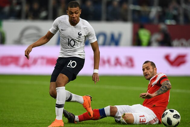France's forward Kylian Mbappe and Russia's defender Fyodor Kudryashov vie for the ball during an international friendly football match between Russia and France at the Saint Petersburg Stadium in Saint Petersburg on March 27, 2018. / AFP PHOTO / FRANCK FIFE        (Photo credit should read FRANCK FIFE/AFP/Getty Images)
