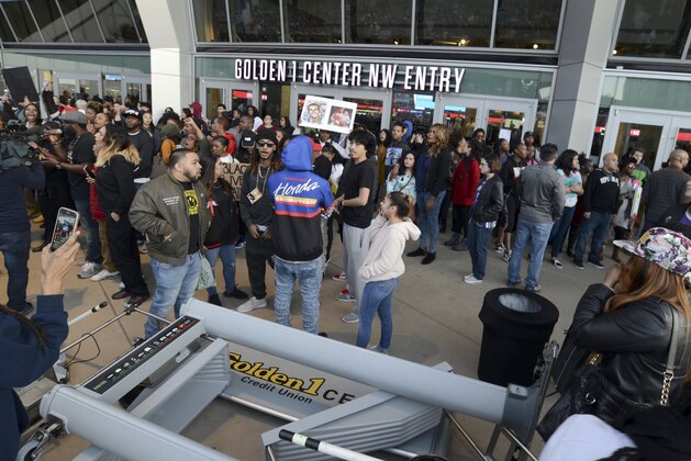 A metal detector lies in the foreground as demonstrators protesting the fatal shooting of an unarmed black man gather outside Golden 1 Center before the scheduled tipoff of an NBA basketball game between the Atlanta Hawks and the Sacramento Kings in Sacramento, Calif., Thursday, March 22, 2018. Hundreds of people rallied for Stephon Clark, a 22-year-old who was shot Sunday in his grandparents' backyard. Police say they feared he had a handgun when they confronted him after reports that he had been breaking windows, but he only had a cellphone. (AP Photo/Robert Petersen)