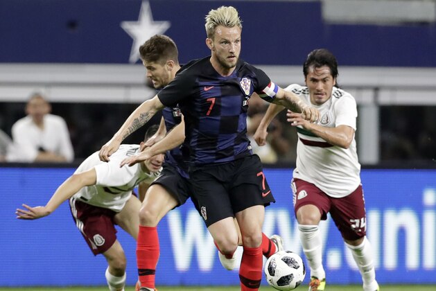 Croatia midfielder Ivan Rakitic (7) leads an attack as Mexico midfielder Jorge Hernández (24) gives chase in the first half of a friendly soccer match in Arlington, Texas, Tuesday, March 25, 2018. (AP Photo/Tony Gutierrez)