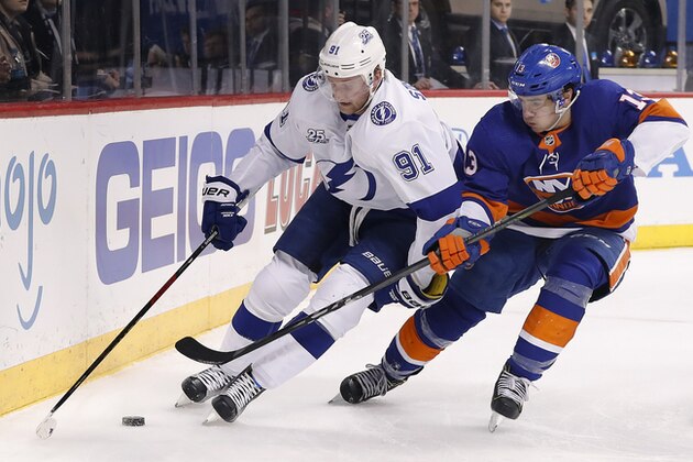 Tampa Bay Lightning center Steven Stamkos (91) controls the puck against New York Islanders center Mathew Barzal (13) during the first period of an NHL hockey game Thursday, March 22, 2018, in New York. (AP Photo/Julie Jacobson)