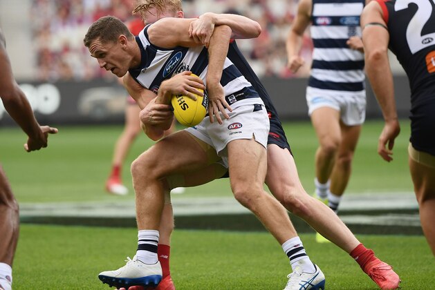 MELBOURNE, AUSTRALIA - MARCH 25:  Joel Selwood of the Cats is tackled by Clayton Oliver of the Demons during the round one AFL match between the Melbourne Demons and the Geelong Cats at Melbourne Cricket Ground on March 25, 2018 in Melbourne, Australia.  (Photo by Quinn Rooney/Getty Images)