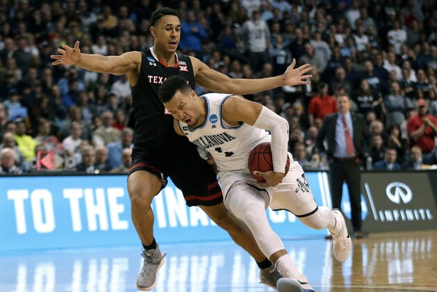 Villanova's Jalen Brunson, front, drives past Texas Tech's Zhaire Smith during the second half of an NCAA men's college basketball tournament regional final, Sunday, March 25, 2018, in Boston. (AP Photo/Elise Amendola)