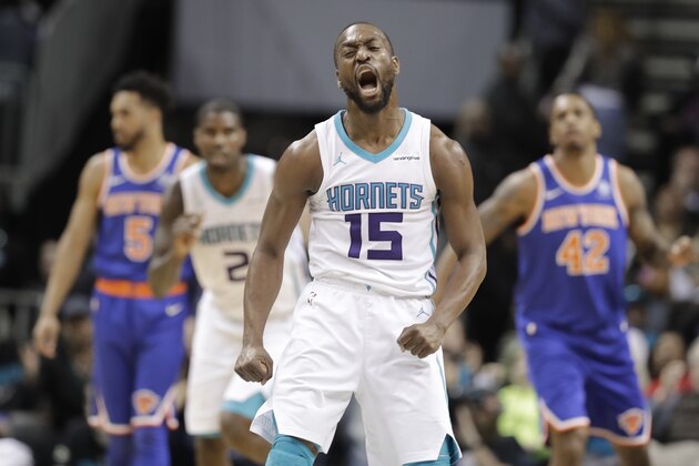 Charlotte Hornets' Kemba Walker (15) reacts to making a 3-point basket against the New York Knicks during overtime of an NBA basketball game in Charlotte, N.C., Monday, March 26, 2018. (AP Photo/Chuck Burton)