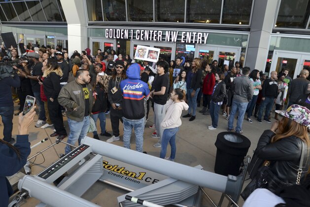 A metal detector lies in the foreground as demonstrators protesting the fatal shooting of an unarmed black man gather outside Golden 1 Center before the scheduled tipoff of an NBA basketball game between the Atlanta Hawks and the Sacramento Kings in Sacramento, Calif., Thursday, March 22, 2018. Hundreds of people rallied for Stephon Clark, a 22-year-old who was shot Sunday in his grandparents' backyard. Police say they feared he had a handgun when they confronted him after reports that he had been breaking windows, but he only had a cellphone. (AP Photo/Robert Petersen)
