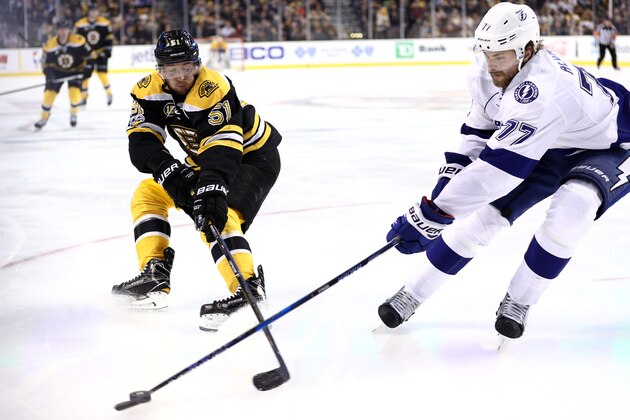 BOSTON, MA - APRIL 4: Ryan Spooner #51 of the Boston Bruins and Victor Hedman #77 of the Tampa Bay Lightning battle for control of the puck during the third period at TD Garden on April 4, 2017 in Boston, Massachusetts. The Bruins defeat the Lightning 4-0. (Photo by Maddie Meyer/Getty Images)