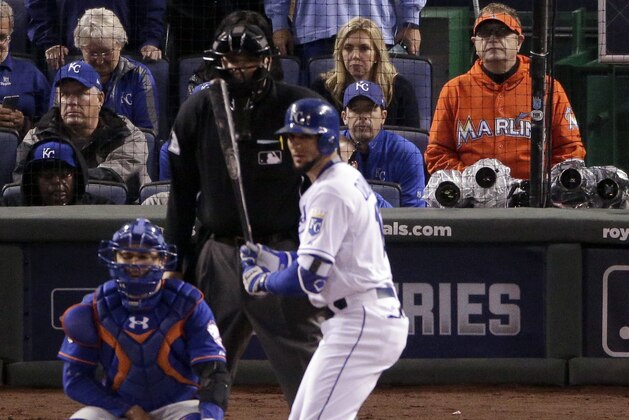 Baseball fan Laurence Leavy, right, watches during the 12th inning of Game 1 of the Major League Baseball World Series between the Kansas City Royals and the New York Mets Tuesday, Oct. 27, 2015, in Kansas City, Mo. (AP Photo/Charlie Riedel)