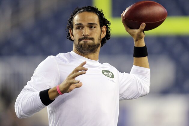 New York Jets quarterback Mark Sanchez, who normally throws right-handed, throws a pass with his left hang before an NFL football between the New England Patriots and the Jets game Thursday, Sept. 12, 2013, in Foxborough. (AP Photo/Charles Krupa)
