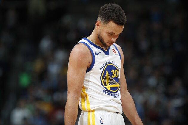 Golden State Warriors guard Stephen Curry reacts at the end of the team's NBA basketball game against the Denver Nuggets on Saturday, Feb. 3, 2018, in Denver. The Nuggets won 115-108. (AP Photo/David Zalubowski)