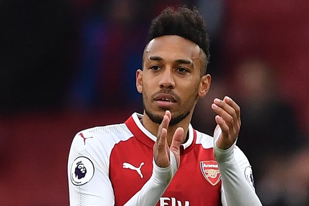 Arsenal's Gabonese striker Pierre-Emerick Aubameyang applauds supporters on the pitch after the English Premier League football match between Arsenal and Watford at the Emirates Stadium in London on March 11, 2018. 
Arsenal won the game 3-0. / AFP PHOTO / Ben STANSALL / RESTRICTED TO EDITORIAL USE. No use with unauthorized audio, video, data, fixture lists, club/league logos or 'live' services. Online in-match use limited to 75 images, no video emulation. No use in betting, games or single club/league/player publications.  /         (Photo credit should read BEN STANSALL/AFP/Getty Images)