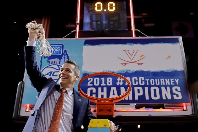 FILE - In this March 10, 2018, file photo, Virginia head coach Tony Bennett holds up the net after defeating North Carolina in the championship game of the NCAA Atlantic Coast Conference men's college basketball tournament, in New York. Bennett was named The Associated Press NCAA college basketball Coach of the Year, Thursday, March 29, 2018. (AP Photo/Julie Jacobson, File)