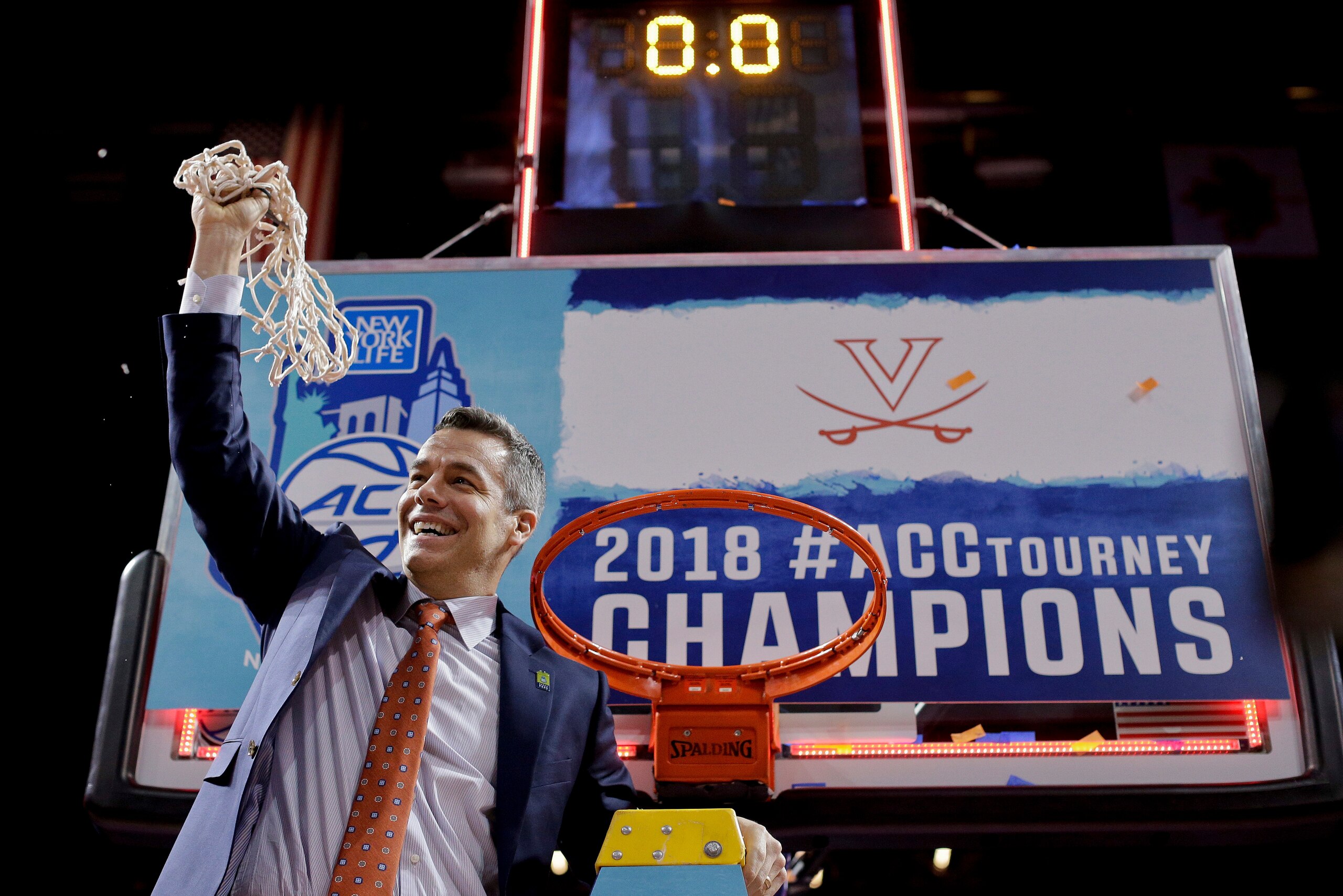 FILE - In this March 10, 2018, file photo, Virginia head coach Tony Bennett holds up the net after defeating North Carolina in the championship game of the NCAA Atlantic Coast Conference men's college basketball tournament, in New York. Bennett was named The Associated Press NCAA college basketball Coach of the Year, Thursday, March 29, 2018. (AP Photo/Julie Jacobson, File)