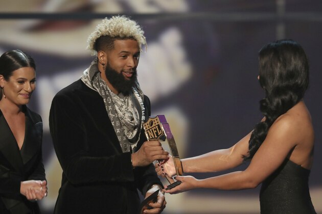 IMAGE DISTRIBUTED FOR NFL - Odell Beckham Jr. of the New York Giants, center, and Lea Michele, left, present the award for AP Defensive Rookie of the Year at the 7th Annual NFL Honors at the Cyrus Northrop Memorial Auditorium on Saturday, Feb. 3, 2018, in Minneapolis, Minnesota. (Photo by Michael Zorn/Invision for NFL/AP Images)