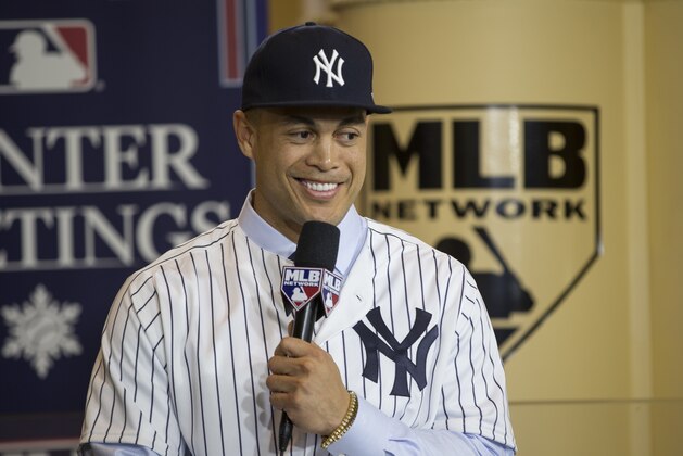 New Yankee Giancarlo Stanton answers questions during a press conference at the Major League Baseball winter meetings in Orlando, Fla., Monday, Dec. 11, 2017. (AP Photo/Willie J. Allen Jr.)