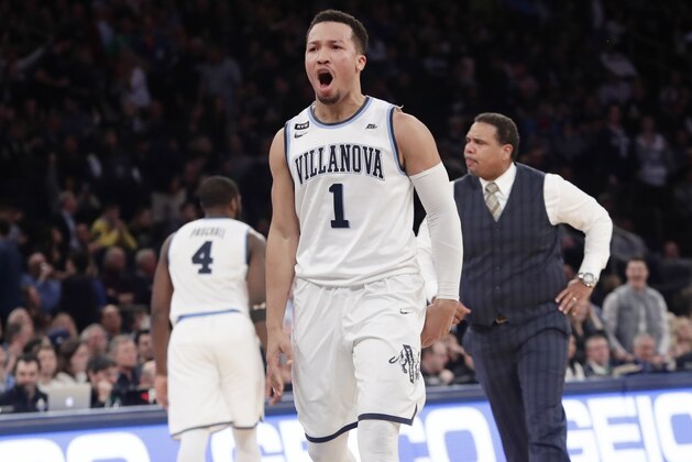 Providence coach Ed Cooley, right, and Villanova's Jalen Brunson (1) react after Brunson made a three point basket during the second half of an NCAA college basketball game in the Big East men's tournament finals Saturday, March 10, 2018, in New York. (AP Photo/Frank Franklin II)