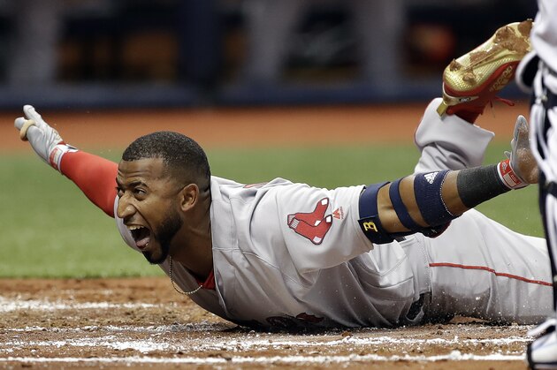 Boston Red Sox's Eduardo Nunez reacts as he slides safely across home plate for an inside-the-park, two-run home run off Tampa Bay Rays starting pitcher Chris Archer in the second inning of an opening day baseball game Thursday, March 29, 2018, in St. Petersburg, Fla. (AP Photo/Chris O'Meara)