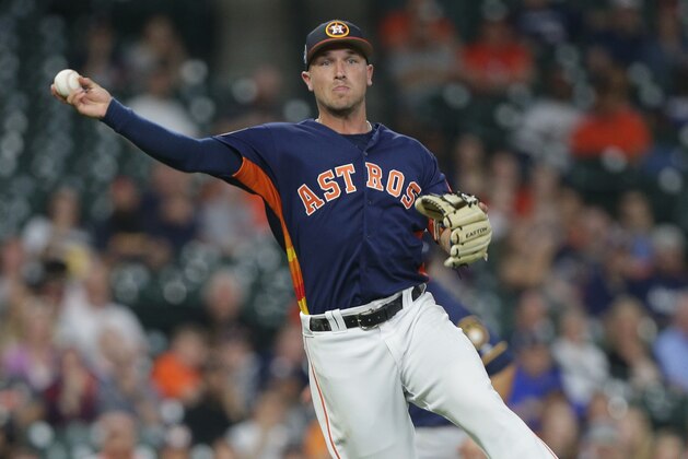 HOUSTON, TX - MARCH 26:  Alex Bregman #2 of the Houston Astros throws out Lorenzo Cain #6 of the Milwaukee Brewers in the third inning during a spring training game at Minute Maid Park on March 26, 2018 in Houston, Texas.  (Photo by Bob Levey/Getty Images)