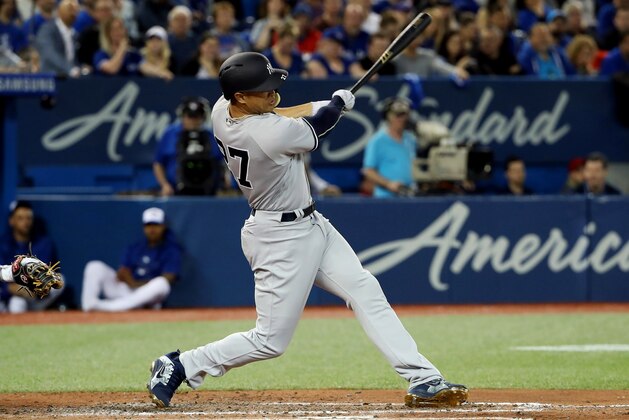 TORONTO, ON - MARCH 29: Giancarlo Stanton #27 of the New York Yankees hits an RBI double in the fifth inning on Opening Day during MLB game action against the Toronto Blue Jays at Rogers Centre on March 29, 2018 in Toronto, Canada. (Photo by Tom Szczerbowski/Getty Images)