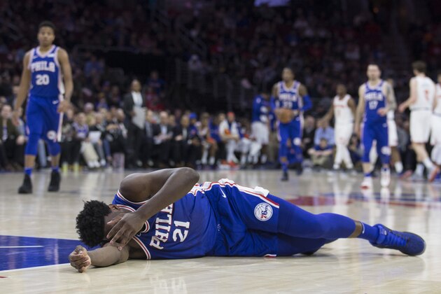 PHILADELPHIA, PA - MARCH 28: Joel Embiid #21 of the Philadelphia 76ers lies on the court after a collision with Markelle Fultz #20 of the Philadelphia 76ers in the second quarter against the New York Knicks at the Wells Fargo Center on March 28, 2018 in Philadelphia, Pennsylvania. NOTE TO USER: User expressly acknowledges and agrees that, by downloading and or using this photograph, User is consenting to the terms and conditions of the Getty Images License Agreement. (Photo by Mitchell Leff/Getty Images)