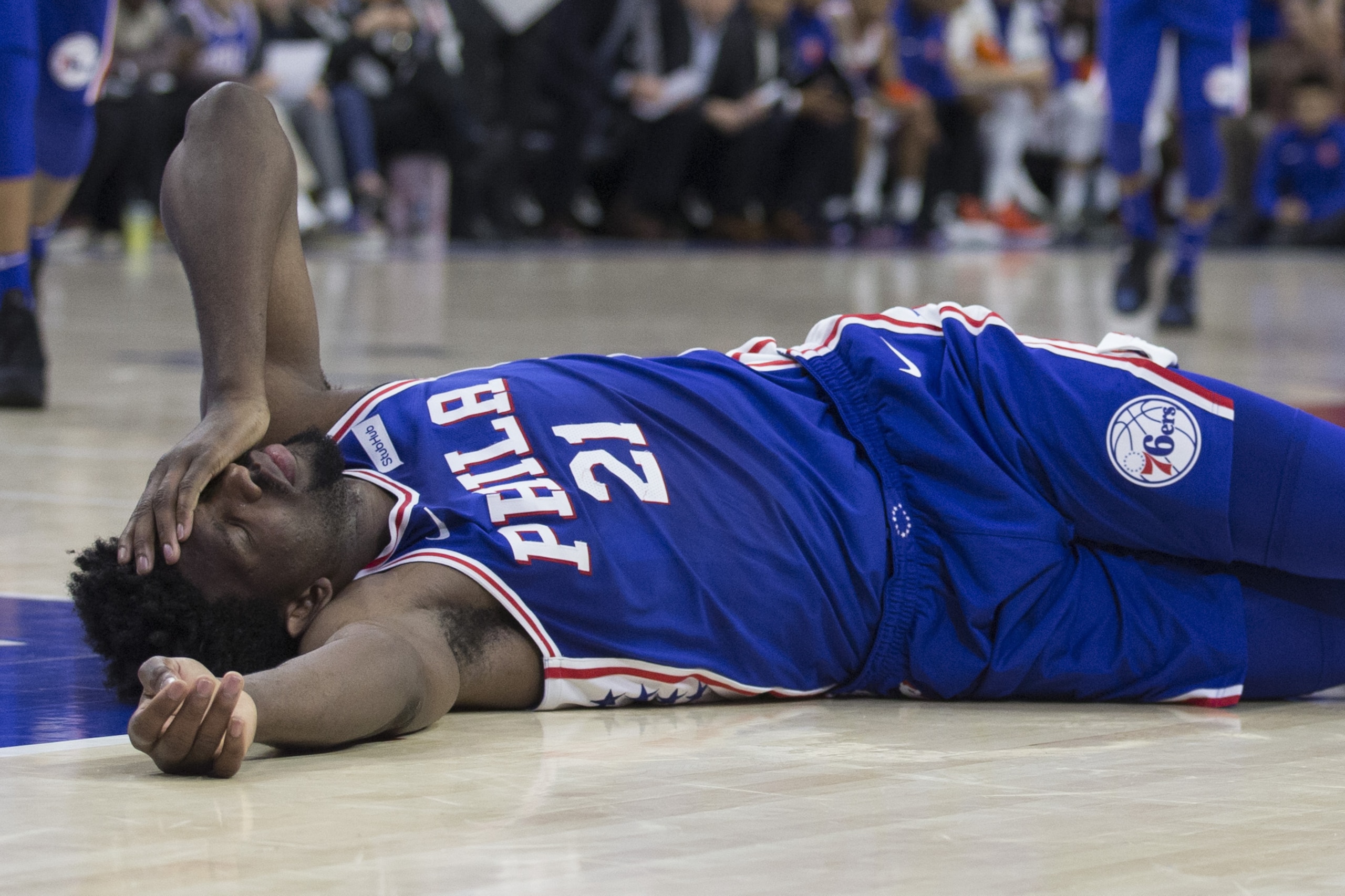 PHILADELPHIA, PA - MARCH 28: Joel Embiid #21 of the Philadelphia 76ers lies on the court after a collision with Markelle Fultz #20 of the Philadelphia 76ers in the second quarter against the New York Knicks at the Wells Fargo Center on March 28, 2018 in Philadelphia, Pennsylvania. NOTE TO USER: User expressly acknowledges and agrees that, by downloading and or using this photograph, User is consenting to the terms and conditions of the Getty Images License Agreement. (Photo by Mitchell Leff/Getty Images)