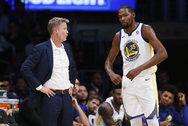 Golden State Warriors head coach Steve Kerr talks to forward Kevin Durant #35 during an NBA basketball game Wednesday, Nov. 29, 2017, in Los Angeles. Golden State Warriors won 127-123 in overtime. (AP Photo/Ringo H.W. Chiu)