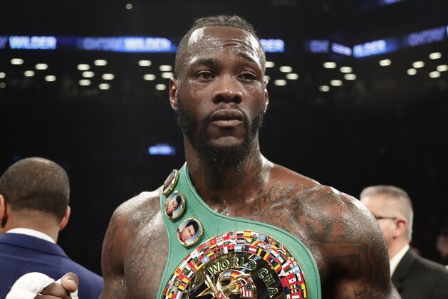 Deontay Wilder poses for photographs after the WBC heavyweight championship bout against Luis Ortiz on Saturday, March 3, 2018, in New York. Wilder won in the 10th round. (AP Photo/Frank Franklin II)