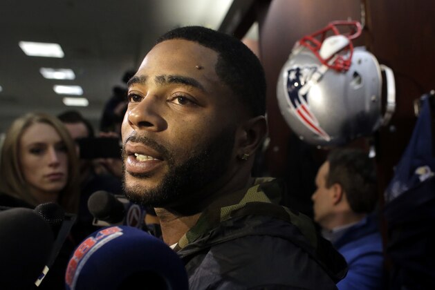 New England Patriots cornerback Malcolm Butler (21) speaks with members of the media in the team's locker room following an NFL football practice, Wednesday, Dec. 13, 2017, in Foxborough, Mass. (AP Photo/Steven Senne)