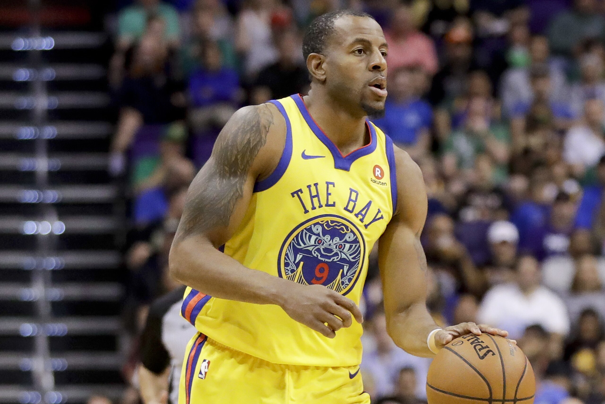 Golden State Warriors forward Andre Iguodala brings the ball down court against the Phoenix Suns during an NBA basketball game in Phoenix, Sunday, March 18, 2018. (AP Photo/Chris Carlson)