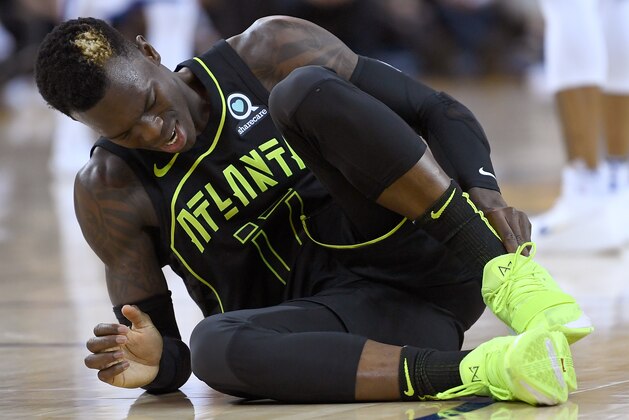OAKLAND, CA - MARCH 23:  Dennis Schroder #17 of the Atlanta Hawks reacts after twisting his ankle against the Golden State Warriors during an NBA basketball game at ORACLE Arena on March 23, 2018 in Oakland, California. NOTE TO USER: User expressly acknowledges and agrees that, by downloading and or using this photograph, User is consenting to the terms and conditions of the Getty Images License Agreement.  (Photo by Thearon W. Henderson/Getty Images)