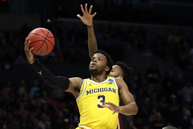 LOS ANGELES, CA - MARCH 24:  Zavier Simpson #3 of the Michigan Wolverines lays the ball up in the first half while taking on the Florida State Seminoles in the 2018 NCAA Men's Basketball Tournament West Regional Final at Staples Center on March 24, 2018 in Los Angeles, California.  (Photo by Ezra Shaw/Getty Images)
