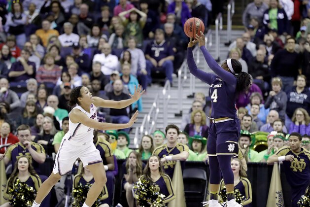 Notre Dame's Arike Ogunbowale, right, hits the game-winning shot as Connecticut's Napheesa Collier, left, watches during overtime in the semifinals of the women's NCAA Final Four college basketball tournament, Friday, March 30, 2018, in Columbus, Ohio. Notre Dame won 91-89. (AP Photo/Ron Schwane)