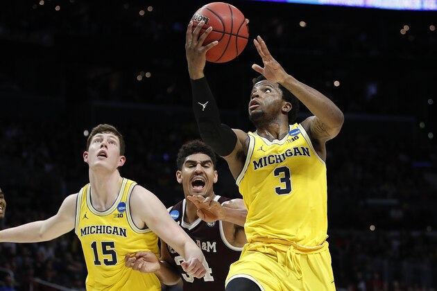 Michigan guard Zavier Simpson (3) shoots against Texas A&M during the first half of an NCAA men's college basketball tournament regional semifinal Thursday, March 22, 2018, in Los Angeles. (AP Photo/Jae Hong)