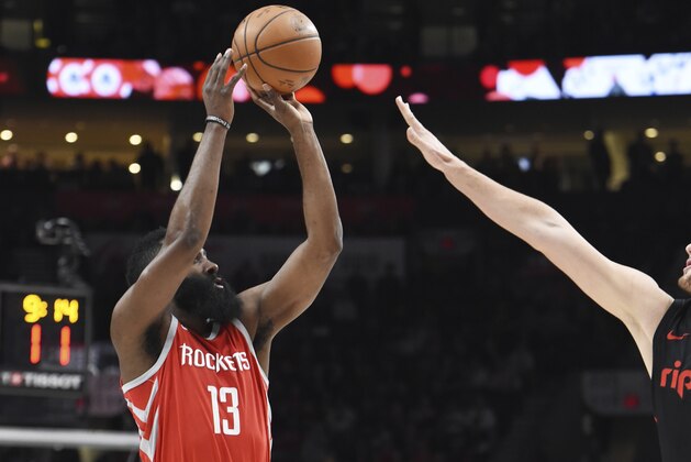 Houston Rockets guard James Harden takes a shot over Portland Trail Blazers center Jusuf Nurkic during the first half of an NBA basketball game in Portland, Ore., Tuesday, March 20, 2018. (AP Photo/Steve Dykes)