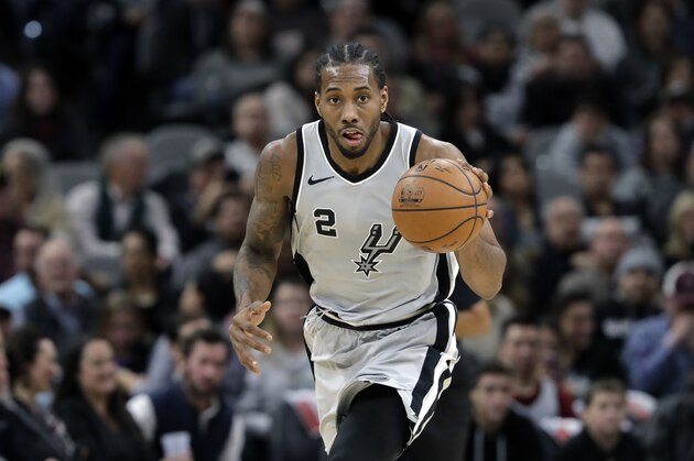 San Antonio Spurs forward Kawhi Leonard (2) moves the ball up court during the second half of an NBA basketball game against the Denver Nuggets, Saturday, Jan. 13, 2018, in San Antonio. San Antonio won 112-80. (AP Photo/Eric Gay)