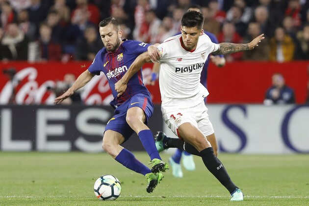 Barcelona's Jordi Alba, left, and Sevilla's, Correa, fight for the ball during La Liga soccer match between Barcelona and Sevilla at the Sanchez Pizjuan stadium, in Seville, Spain on Saturday, March 31, 2018. (AP Photo/Miguel Morenatti)