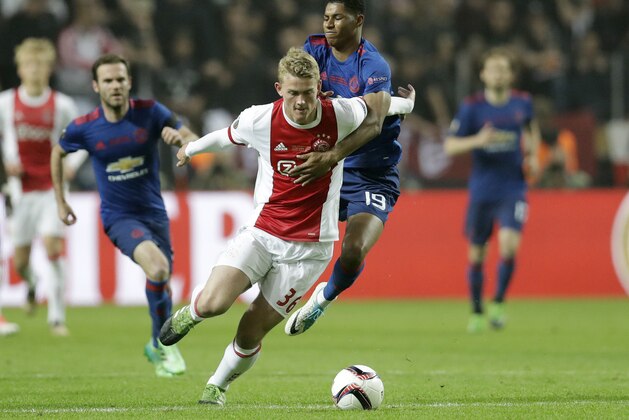 Manchester's Marcus Rashford, right, holds Ajax's Matthijs de Ligt during the soccer Europa League final between Ajax Amsterdam and Manchester United at the Friends Arena in Stockholm, Sweden, Wednesday, May 24, 2017. (AP Photo/Michael Sohn)