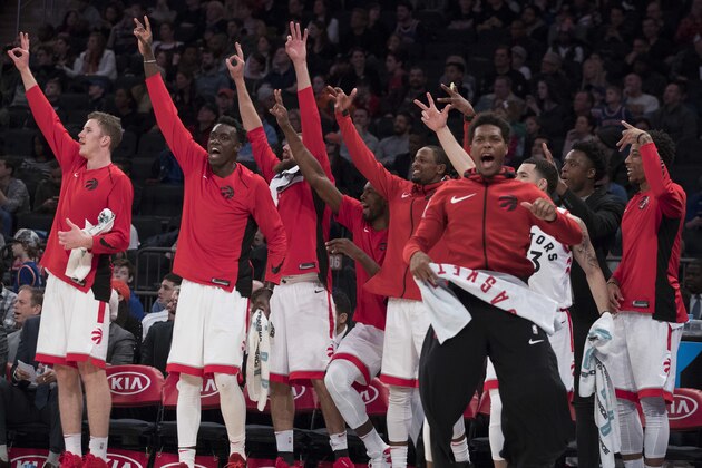 The Toronto Raptors bench celebrates a three-point goal in the final minutes of the second half of an NBA basketball game against the New York Knicks, Sunday, March 11, 2018, at Madison Square Garden in New York. The Raptors won 132-106. (AP Photo/Mary Altaffer)