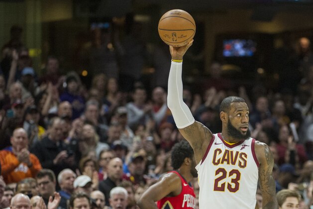 Cleveland Cavaliers' LeBron James celebrates during the first half of an NBA basketball game against the New Orleans Pelicans in Cleveland, Friday, March 30, 2018. James broke Michael Jordan's NBA record by scoring at least 10 points in his 867th straight regular-season game. (AP Photo/Phil Long)