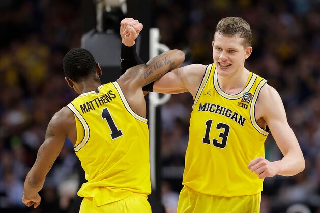 Michigan's Moritz Wagner (13) celebrates with Charles Matthews (1) during the second half in the semifinals of the Final Four NCAA college basketball tournament against Loyola-Chicago, Saturday, March 31, 2018, in San Antonio. (AP Photo/Eric Gay)
