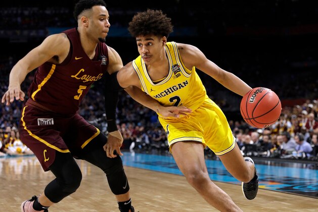 Michigan guard Jordan Poole drives past Loyola-Chicago guard Marques Townes, left, during the second half in the semifinals of the Final Four NCAA college basketball tournament, Saturday, March 31, 2018, in San Antonio. (AP Photo/David J. Phillip)