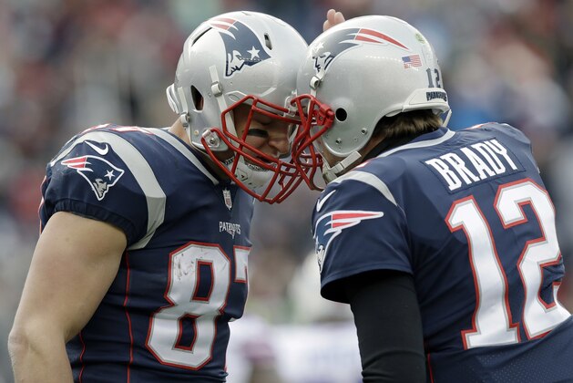 New England Patriots quarterback Tom Brady, right, celebrates his touchdown pass to tight end Rob Gronkowski, left, during the first half of an NFL football game against the Buffalo Bills, Sunday, Dec. 24, 2017, in Foxborough, Mass. (AP Photo/Charles Krupa)