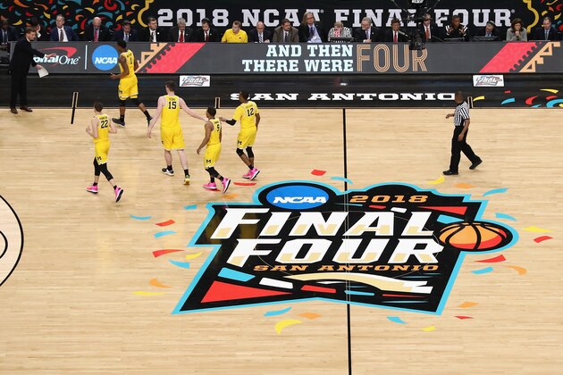SAN ANTONIO, TX - MARCH 31: The Michigan Wolverines walk to the bench in the first half against the Loyola Ramblers during the 2018 NCAA Men's Final Four Semifinal at the Alamodome on March 31, 2018 in San Antonio, Texas.  (Photo by Ronald Martinez/Getty Images)