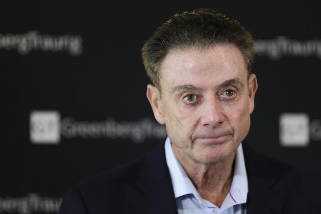 Former Louisville basketball coach Rick Pitino talks to reporters during a news conference in New York, Wednesday, Feb. 21, 2018. Pitino held the news conference in the wake of an NCAA decision in a sex scandal case that strips the Cardinals program of 123 victories, a national championship and $600,000 in post-season revenue. (AP Photo/Seth Wenig) Former Louisville basketball coach Rick Pitino talks to reporters during a news conference in New York, Wednesday, Feb. 21, 2018. Pitino held the news conference in the wake of an NCAA decision in a sex scandal case that strips the Cardinals program of 123 victories, a national championship and $600,000 in post-season revenue. (AP Photo/Seth Wenig)