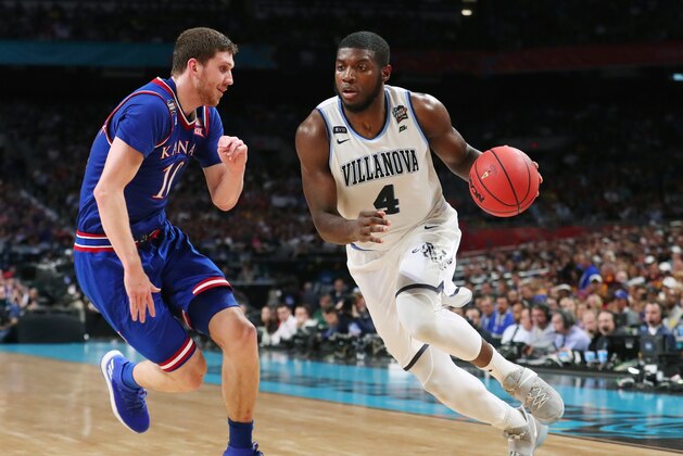 SAN ANTONIO, TX - MARCH 31:  Eric Paschall #4 of the Villanova Wildcats is defended by Sviatoslav Mykhailiuk #10 of the Kansas Jayhawks in the second half during the 2018 NCAA Men's Final Four Semifinal at the Alamodome on March 31, 2018 in San Antonio, Texas.  (Photo by Tom Pennington/Getty Images)