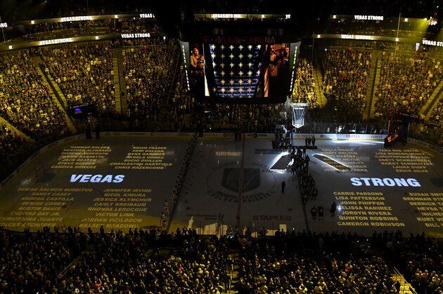 LAS VEGAS, NV - MARCH 31:  Names of the 58 victims of the October 1, 2017 mass shooting in Las Vegas are projected on the ice as the Vegas Golden Knights hang a banner in the rafters with 58 stars and the names of all the victims of the shooting as they retire the number 58 in honor of the 58 victims before a game against the San Jose Sharks at T-Mobile Arena on March 31, 2018 in Las Vegas, Nevada. The Golden Knights won 3-2 and clinched the Pacific Division title.  (Photo by Ethan Miller/Getty Images)