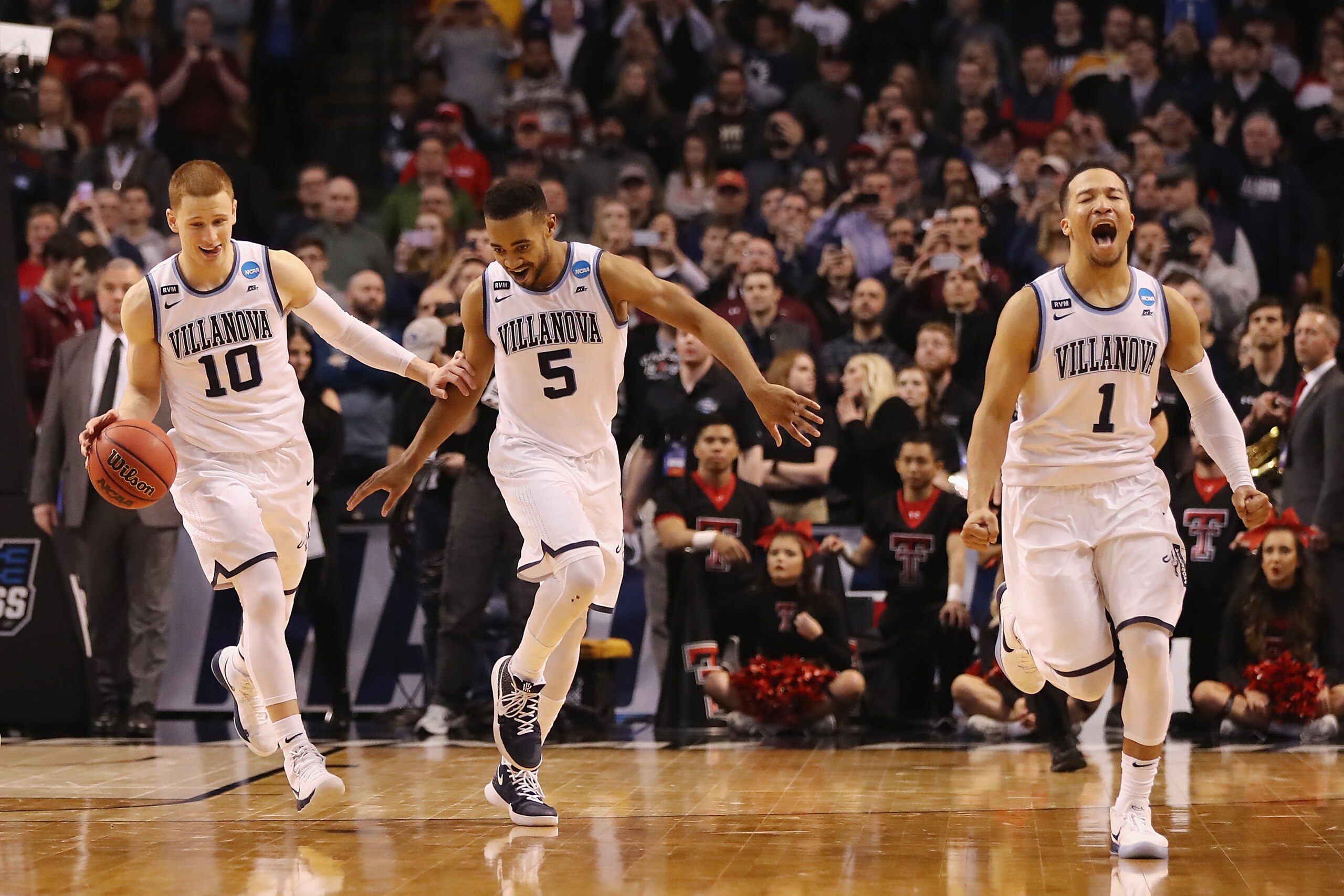 BOSTON, MA - MARCH 25:  Donte DiVincenzo #10, Phil Booth #5, and Jalen Brunson #1 of the Villanova Wildcats celebrate defeating the Texas Tech Red Raiders 71-59 in the 2018 NCAA Men's Basketball Tournament East Regional to advance to the 2018 Final Four at TD Garden on March 25, 2018 in Boston, Massachusetts.  (Photo by Elsa/Getty Images)