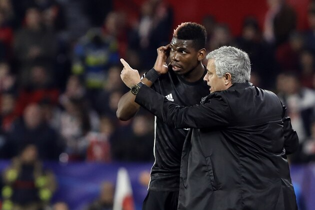 Manchester United manager Jose Mourinho, right, talks to Manchester United's Paul Pogba during the Champions League round of sixteen first leg soccer match between Sevilla FC and Manchester United at the Ramon Sanchez Pizjuan stadium in Seville, Spain, Wednesday, Feb. 21, 2018. (AP Photo/Miguel Morenatti)